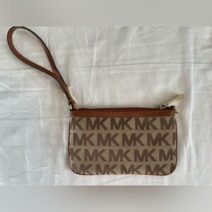 Michael Kor’s Wristlet with Monogrammed Canvas and Gold Hardware